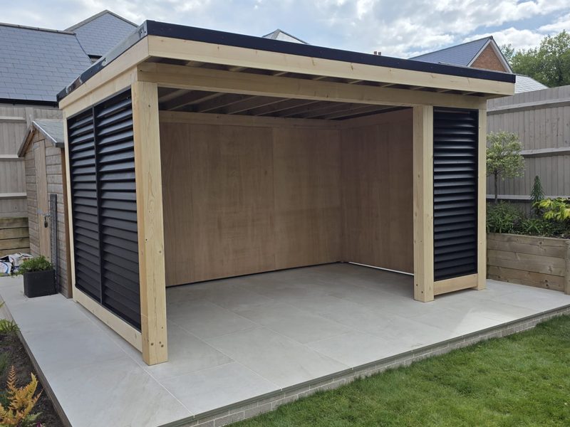 Cedar-framed garden room with adjustable black louvred screens