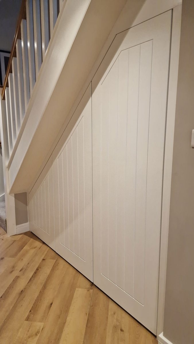 Bespoke understairs storage with pull-out drawers in a Kent home