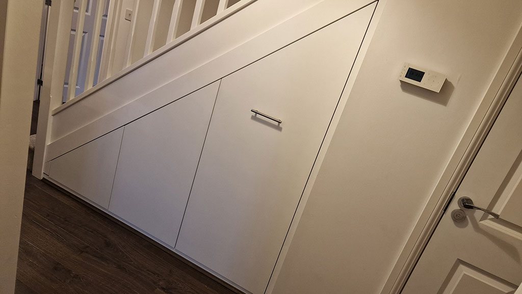 Fitted understairs cupboards and shelving installed by Brothers Carpentry